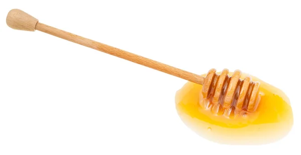 Louže transparentní medu a dřevěnou tyčí — Stock fotografie