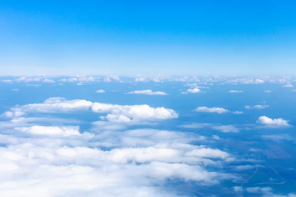 Above view clouds and earth horizon from airplane — Stock Photo, Image