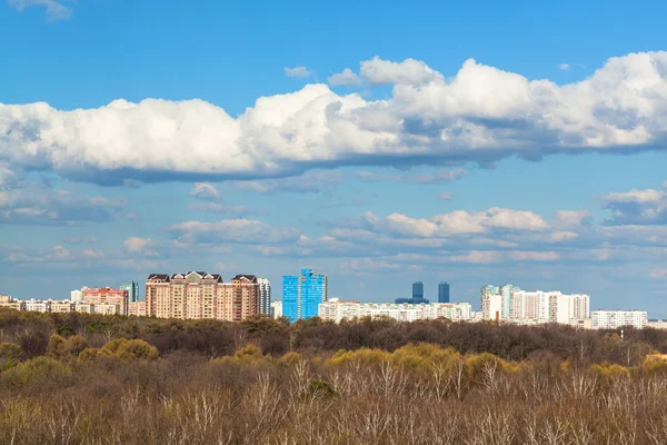 Blue sky with cloud over city and forest in spring — Stockfoto