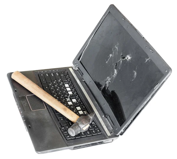 Old broken laptop with hammer on keyboard — Stock Photo, Image