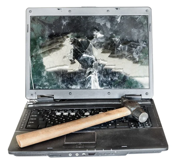 Direct view of old broken laptop with hammer — Stock Photo, Image