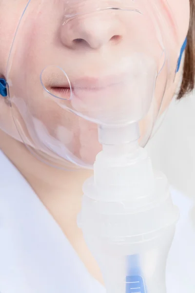 Girl inhales with face mask of nebuliser close up — Stock Photo, Image