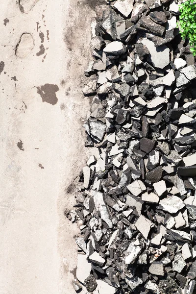 Top view of used asphalt stones on side of road — Stock Photo, Image