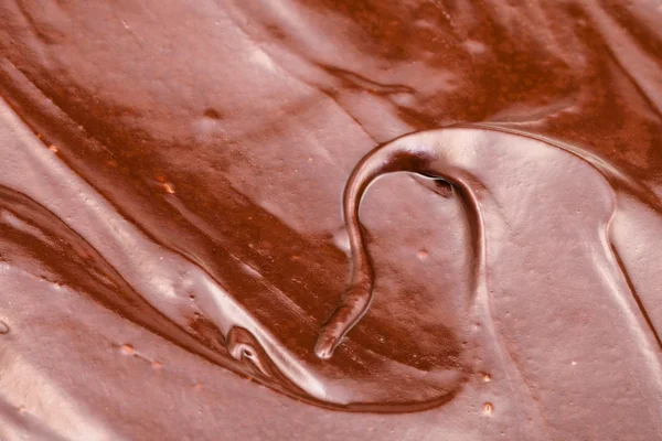 Oberfläche aus süßer geschmolzener Milchschokolade — Stockfoto