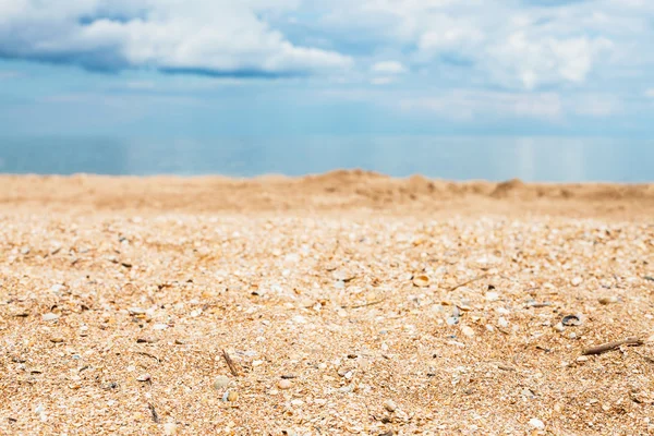 beach close up and white clouds over blue sea