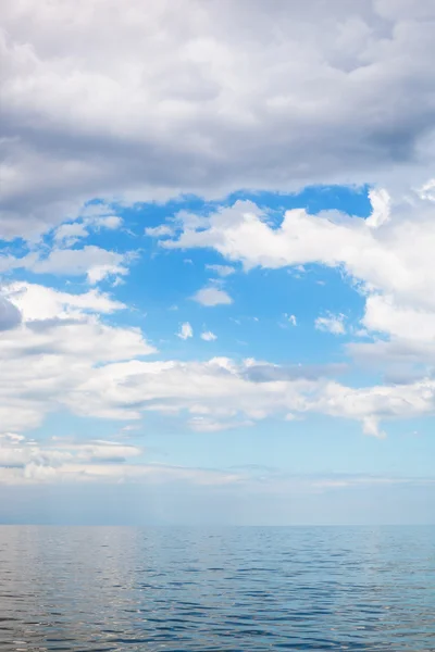 Cumulus clouds over calm blue water Sea of Azov — Stock Photo, Image