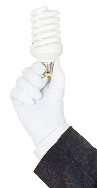 Hand in business suit and glove holds CFL lamp — Stock Photo, Image