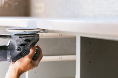 worker finishing countertop from artificial stone clipart