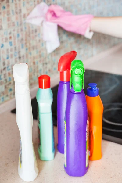 plastic bottles with detergents on kitchen worktop