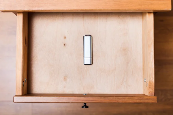 Closed flash drive in open drawer — Stock Photo, Image