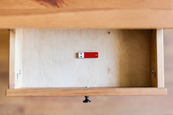 Little red flash drive in open drawer — Stock Photo, Image