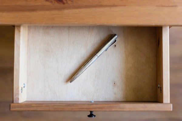 Old silver ballpen in open drawer — Stock Photo, Image