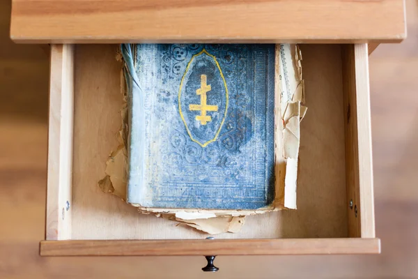 Shabby ritual book in open drawer — Stock Photo, Image