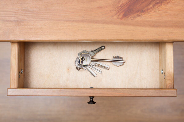 bunch of door keys on ring in open drawer