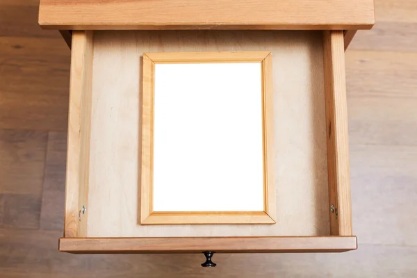 Simple picture frame in open drawer — Stock Photo, Image