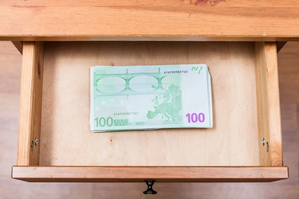 Stack of one hundred euro banknotes in open drawer — Stock Photo, Image