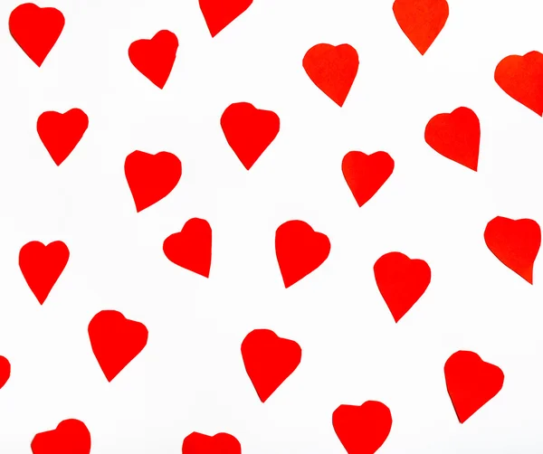 Red hearts cut out from paper on white — Stock Photo, Image