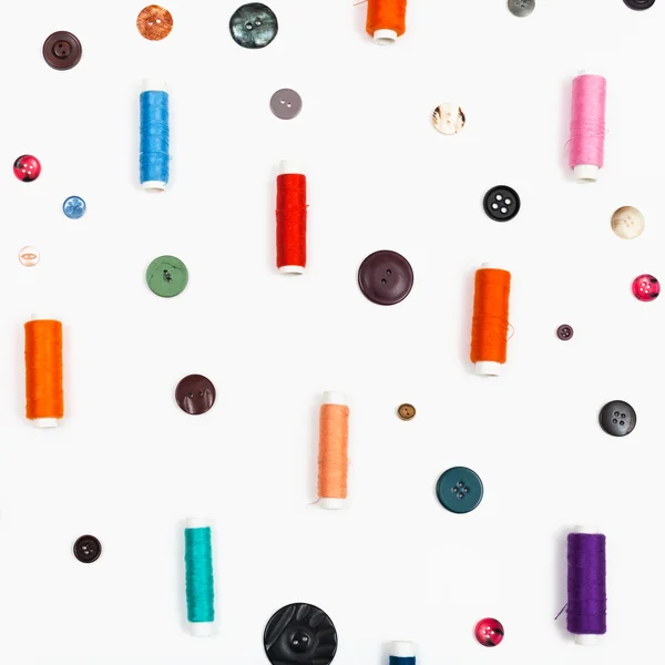 Spools of sewing thread and different buttons — Stock Photo, Image