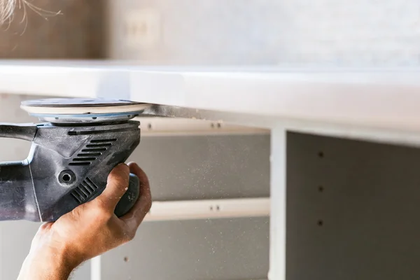 Worker finishing countertop from artificial stone — Stock Image Worker finishing countertop from artificial stone Royalty Free Stock Images