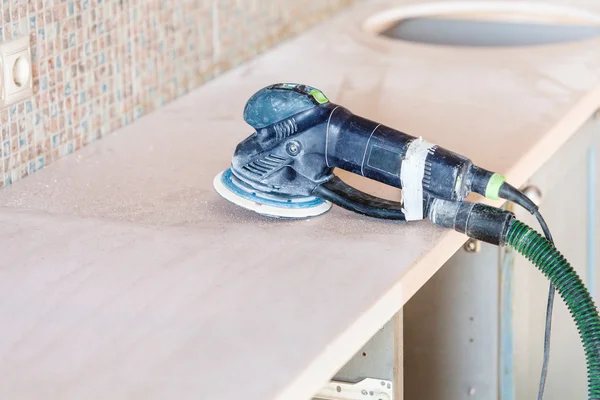 Random orbital sander on new countertop — Stock Image Random orbital sander on new countertop Stock Image