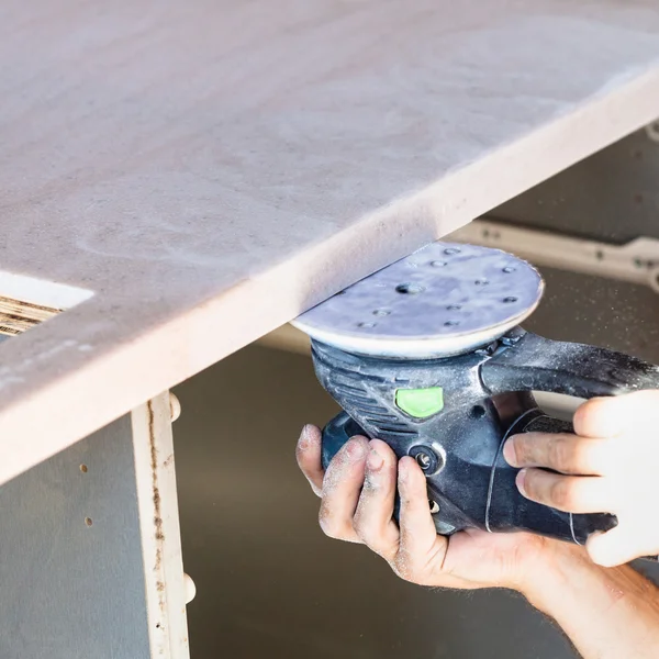 Worker polishing worktop from artificial stone — Stock Image Worker polishing worktop from artificial stone Royalty Free Stock Images