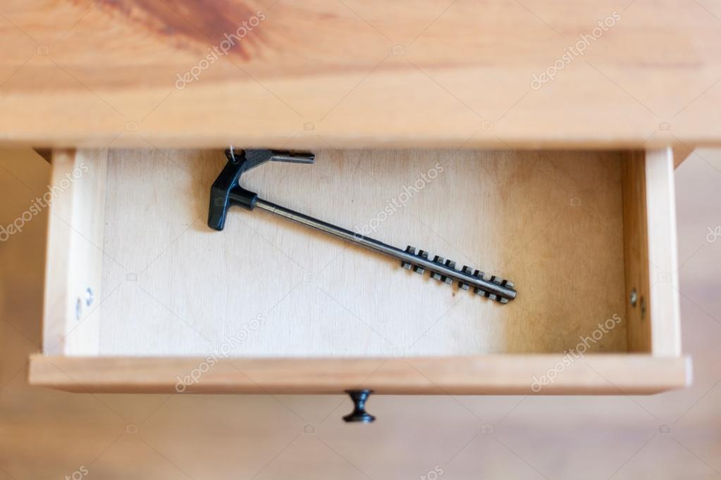 Long latchkey in open drawer Stock Photo by ©vvoennyy 120575484