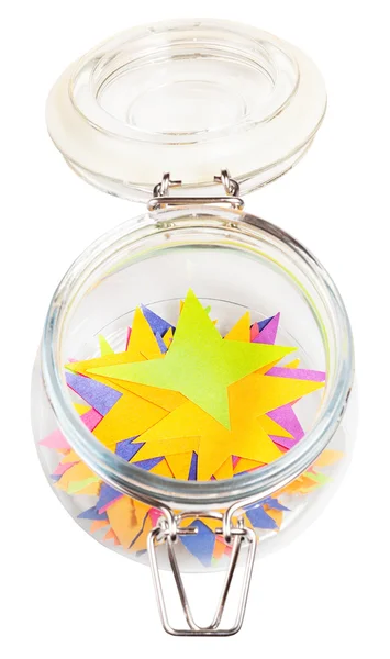 Many stars cut out from paper in open glass jar — Stock Photo, Image
