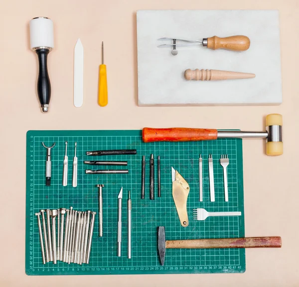 Above view of various tools for leatherwork — Stock Photo, Image