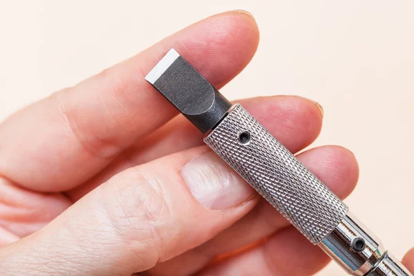 Blade of Swivel knife on fingers close up — Stock Photo, Image