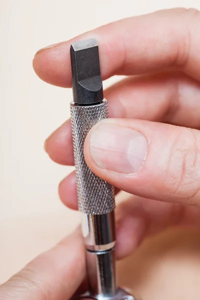Swivel knife in hand close up — Stock Photo, Image