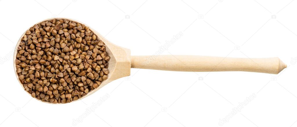 top view of wood spoon with roasted buckwheat grains isolated on white background