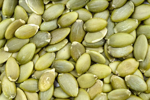 Voedsel Achtergrond Veel Gepelde Pompoenpitten — Stockfoto