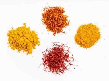 top view of saffron and natural substitutes (crocus threads, turmeric powder, safflower petals, ground tagetes) on white plate clipart