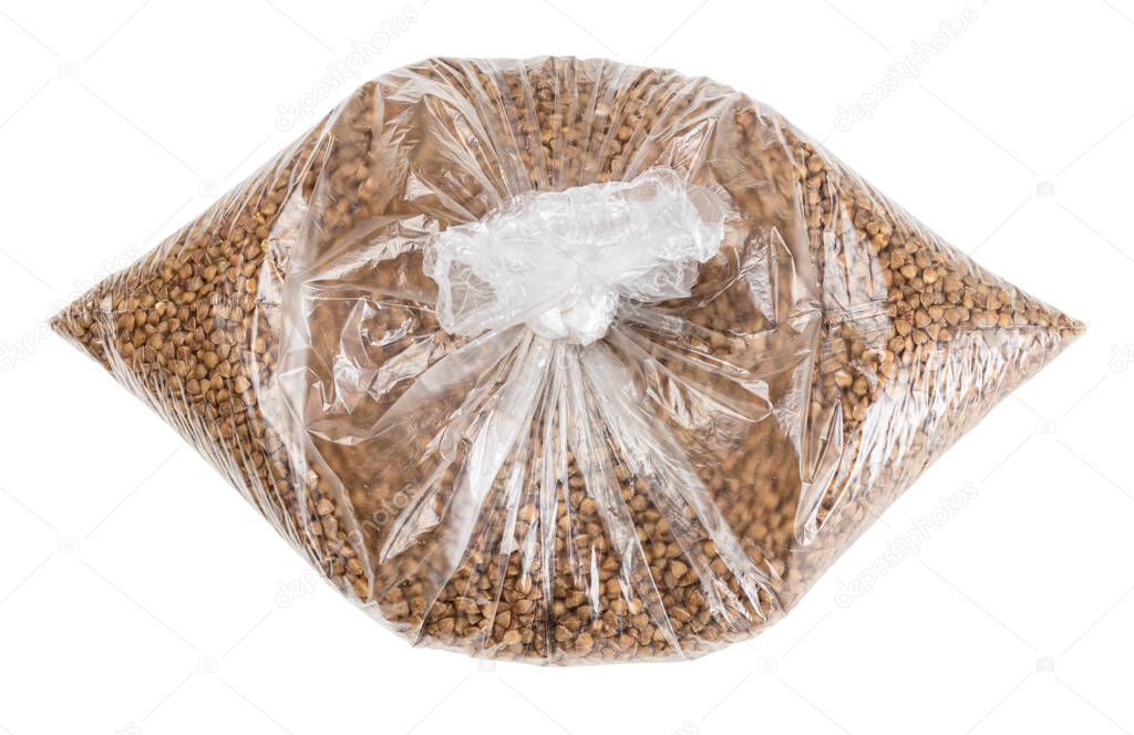brown buckwheat groats in tied plastic bag isolated on white background
