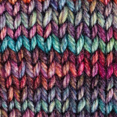 textile square background - pied hand-knitted woolen cloth close up