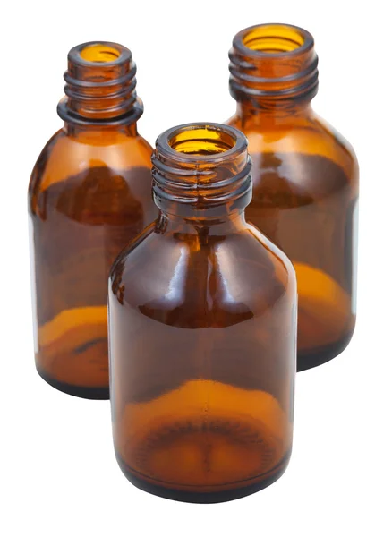 Tres pequeñas botellas de farmacia ovaladas de vidrio marrón abierto —  Fotos de Stock
