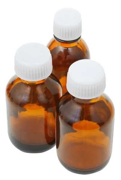Three small closed brown glass pharmacy bottles — Stock Photo, Image