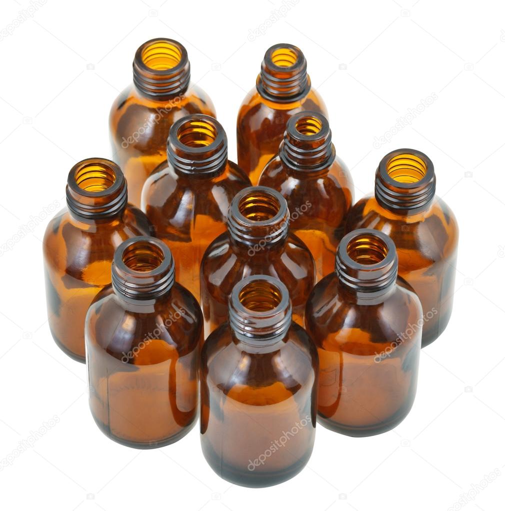 many small open brown glass oval pharmacy bottles