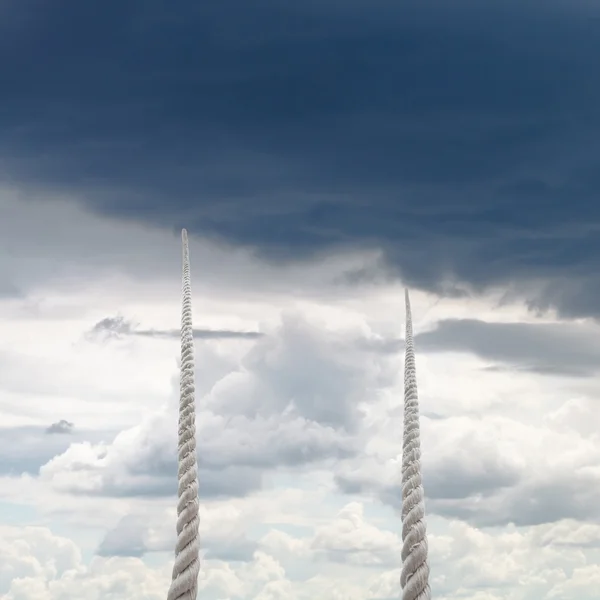 Two ropes rise to sky with rainy clouds — Stock Photo, Image