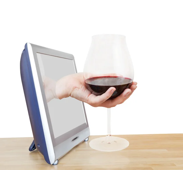 Hand holding big glass with red wine leans out TV — Stock Photo, Image