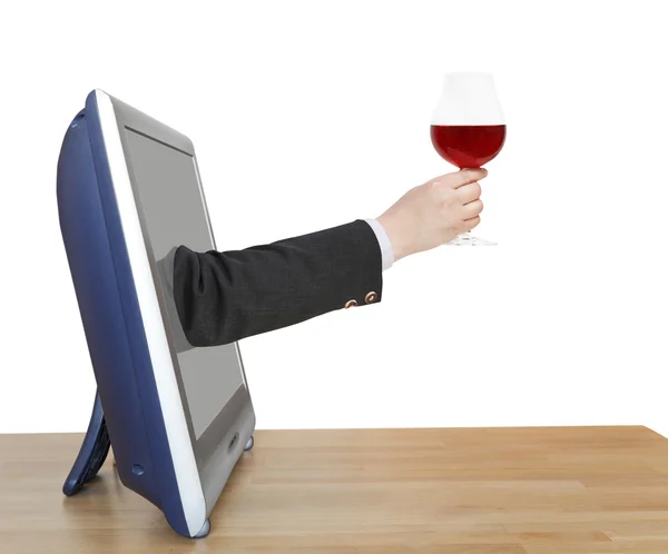 Red wine glass in businessman hand leans out TV — Stock Photo, Image