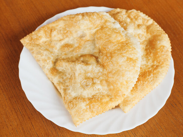 top view of cheburek pie on white plate