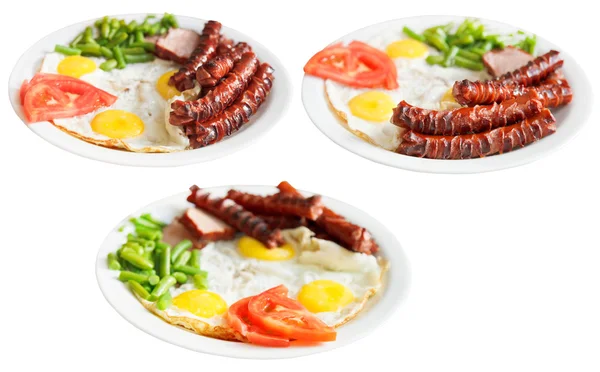 Three plates with fried eggs and sausages isolated — Stock Photo, Image