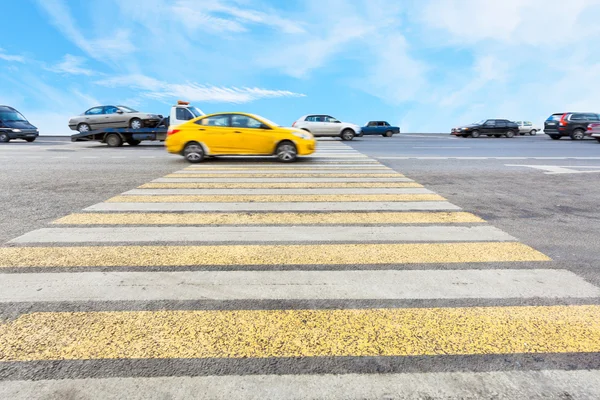 Cab at yellow and white crossing zebra — Stock Photo, Image