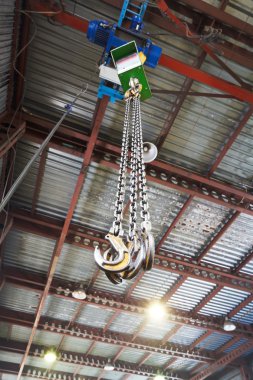 hooks of weigher bridge crane in warehouse clipart