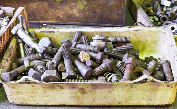 Many old bolts on workbench in turnery — Stock Photo, Image