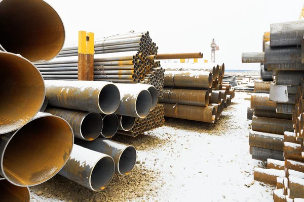 Many steel pipes on outdoor warehouse — Stock Photo, Image