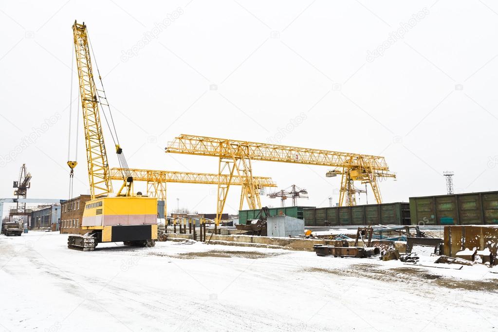 view with different cranes in open storage area
