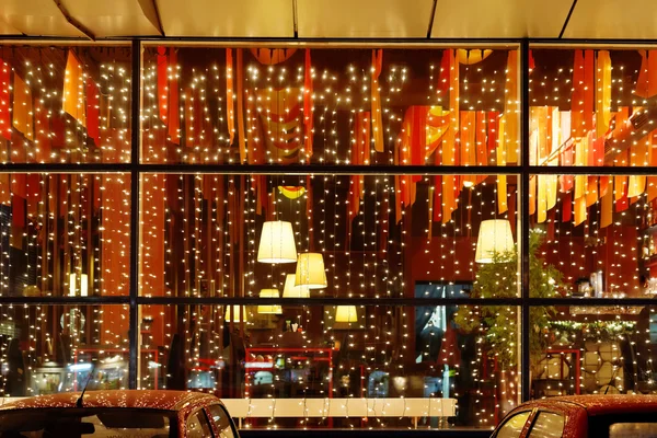 Christmas illumination of restaurant window — Stock Photo, Image