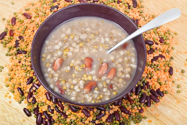 Top view of mess of pottage in bowl with tablespoon — стоковое фото